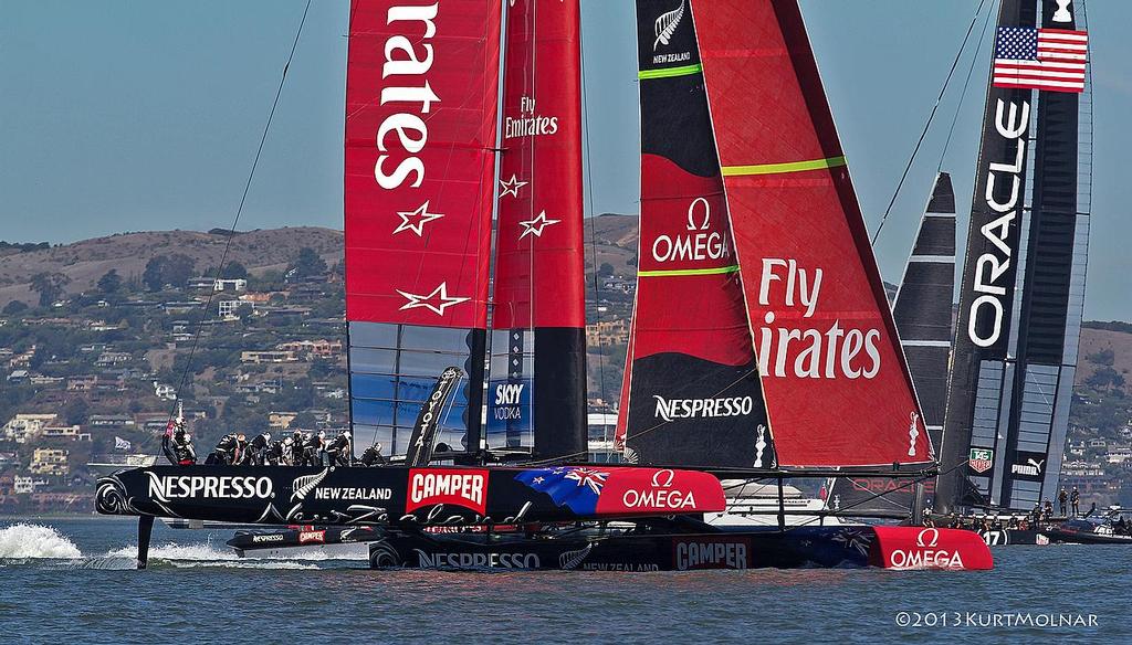 Emirates Team NZ crosses behind Oracle Team USA on Day 13, America’s Cup 2013 © Kurt Molnar
